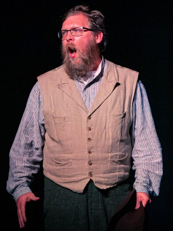 Shawn Ennis performing on stage during theatre production Paint Your Wagon